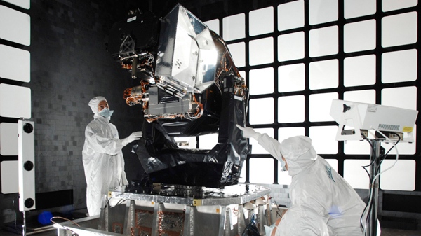This 2009 photo provided by Ball Aerospace and Technologies Corp., shows technicians working on the Space-Based Space Surveillance satellite in Boulder, Colorado. (AP / Ball Aerospace and Technologies Corp.)