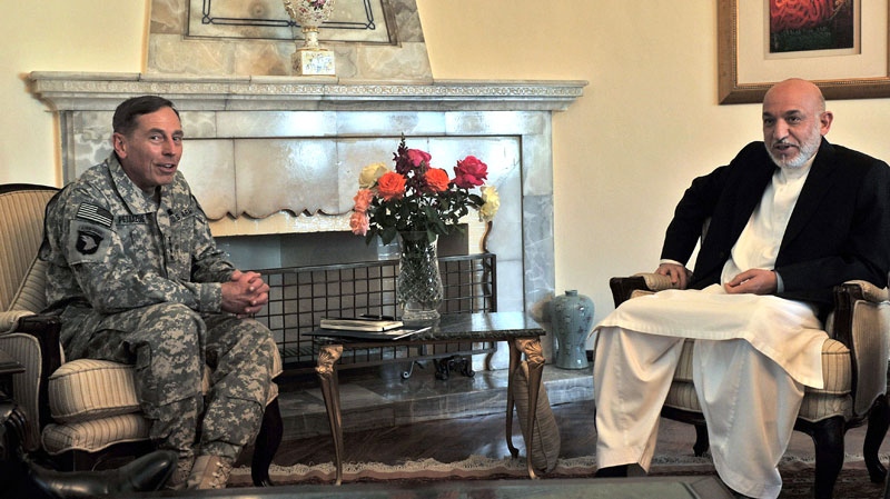 Afghan President Hamid Karzai, right, and commander of NATO forces in Afghanistan U.S. Gen. David Petraeus talk during a meeting at the Presidential Palace in Kabul, Afghanistan, on Saturday, July 3, 2010. (AP / Massoud Hossaini)