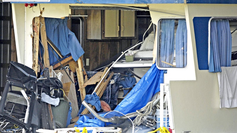 A speed boat is seen inside of a houseboat at a storage area behind Captain's Village Marina in Shuswap Lake, B.C., on July 4, 2010. The speed boat crashed into the houseboat late Saturday night in Magna Bay killing one and injuring others. (Daniel Hayduk / THE CANADIAN PRESS)