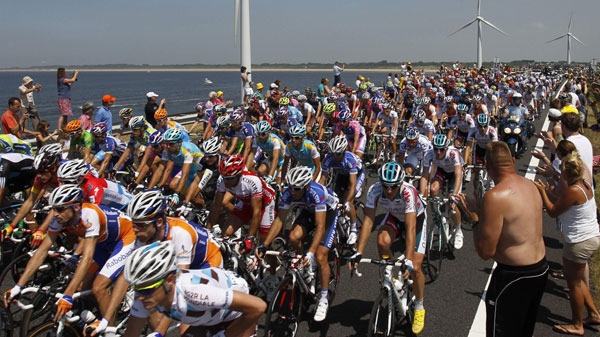 The pack passes Haringvliet storm barrier, south western Netherlands, during the first stage of the Tour de France cycling race over 223,5 kilometers with start in Rotterdam, Netherlands and finish in Brussels, Belgium, Sunday July 4, 2010. (AP Photo / Christophe Ena)