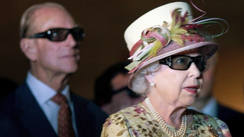 Queen Elizabeth II, right, and Prince Phillip wear 3-D glasses as they view a screening at Pinewood Toronto Studios on Monday, July 5, 2010. (Chris Young / THE CANADIAN PRESS)