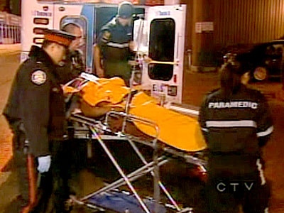 The teenager, suffering from a serious gunshot wound, is taken out of an ambulance outside St. Michael's hospital.