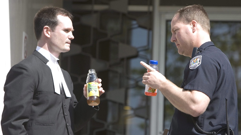 Const. Ryan O'Neill, right, speaks with police lawyer Bruce Jordan outside the courthouse in Victoria, British Columbia, Thursday, May 8, 2008. (Jonathan Hayward / THE CANADIAN PRESS)
