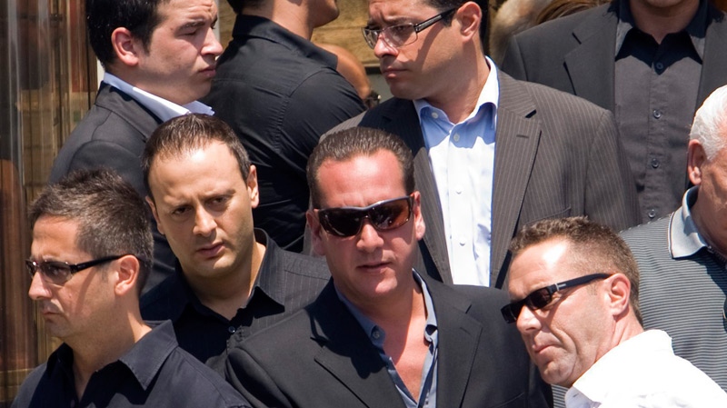Leonardo Rizzuto, right, son of jailed Mafia 'godfather' Vito Rizzuto, leaves the church after funeral services for reputed organized crime leader Agostino Cuntrera in Montreal, Monday, July 5, 2010. (Ryan Remiorz / THE CANADIAN PRESS)
