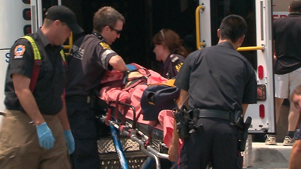 Paramedics load the shooting victim into an ambulance on Tuesday, July 6, 2010.
