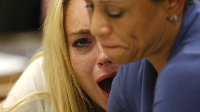 Lindsay Lohan reacts with her attorney Shawn Chapman Holley after the sentencing by Superior Court Judge Marsha Reve during a hearing in Beverly Hills, Calif., Tuesday, July 6, 2010. (AP / David McNew)