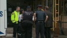 Police and Toronto EMS personnel gather outside the apartment building on Victoria Park Avenue on Friday, July 9, 2010.