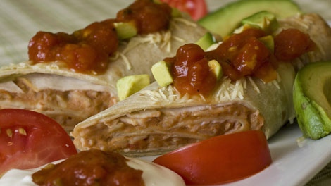 A chicken, cheese and brown rice burrito is seen in this March 31, 2010 photo. Thanks to their easy adaptability burritos are a prefect weeknight meal for families with varied and sometimes finicky taste preferences. (AP Photo/Larry Crowe)