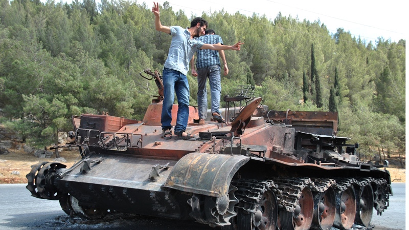 A burned Syrian military tank in Saraqeb town, in the northern province of Idlib, Syria.
