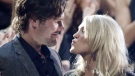 Carrie Underwood kisses her boyfriend Mike Fisher of the NHL Ottawa Senators as she won "Video of the Year" at the 2010 CMT Awards in Nashville, Tenn. Wednesday, June 9, 2010. (AP Photo/M. Spencer Green)