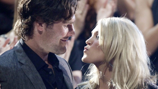 Carrie Underwood kisses her boyfriend Mike Fisher of the NHL Ottawa Senators as she won "Video of the Year" at the 2010 CMT Awards in Nashville, Tenn. Wednesday, June 9, 2010. (AP Photo/M. Spencer Green)