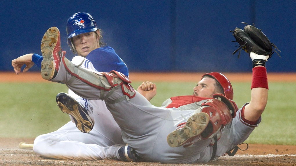 Toronto Blue Jays' Colby Rasmus is out at home plate as Los Angeles Angels catcher Bobby Wilson 