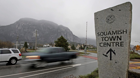 The Stawamus Chief mountain is pictured at left as vehicles drive out of the town centre in Squamish, B.C., on Wednesday November 18, 2009. Carved out of British Columbia's rugged coastal mountains, where the winding highway from Vancouver kisses the coast of Howe Sound one last time before rising up toward Whistler, the logging town of Squamish once billed itself as the "Heart of 2010." That is, until Olympic officials ordered the community to stop, arguing the slogan violated their fiercely guarded trademarks. THE CANADIAN PRESS/Darryl Dyck