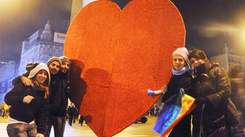Supporters of same sex marriage hold a heart as they pose in front of Buenos Aires' obelisk early Thursday July 15, 2010 after Argentina legalized same-sex marriage. (AP / Rolando Andrade Stracuzzi)