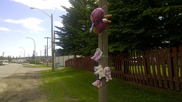 Memorial set up at the site where a toddler was fatally struck by a vehicle in Hinton.