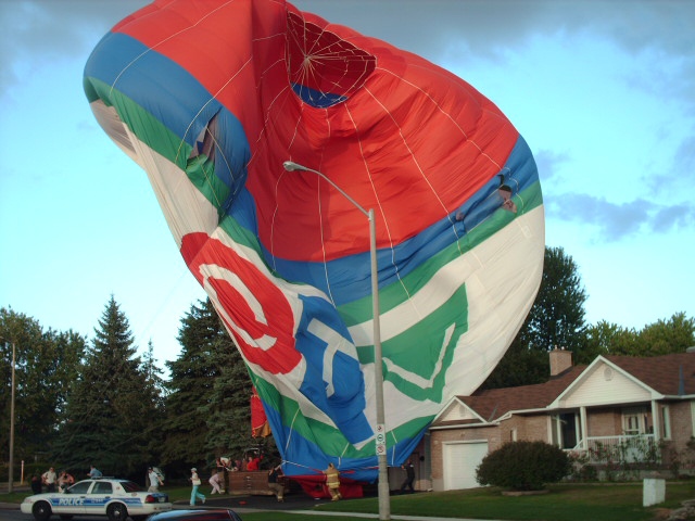 A Sundance hot air balloon makes an emergency landing on the front lawn of a home on Meadowlands Drive, Wednesday, July 14, 2010. Viewer photo submitted by: Chris Ziraldo