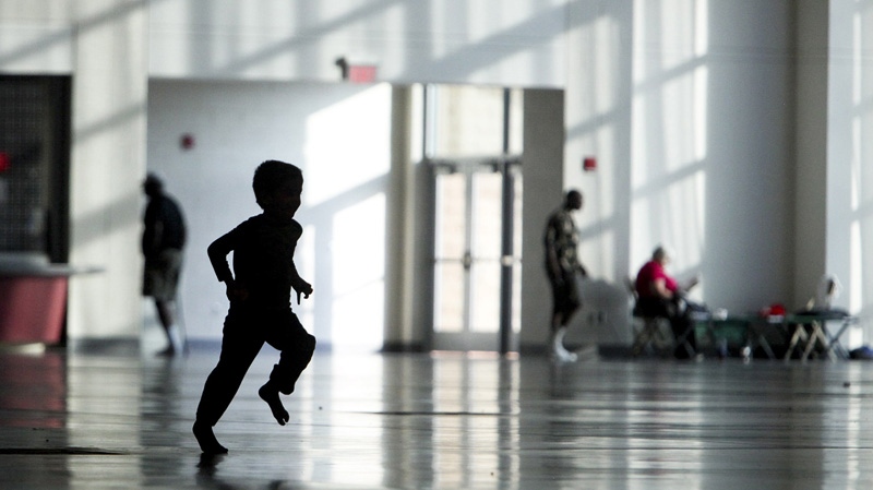 A child runs in a Red Cross shelter on Monday, July 2, 2012, in Roanoke, Virginia.