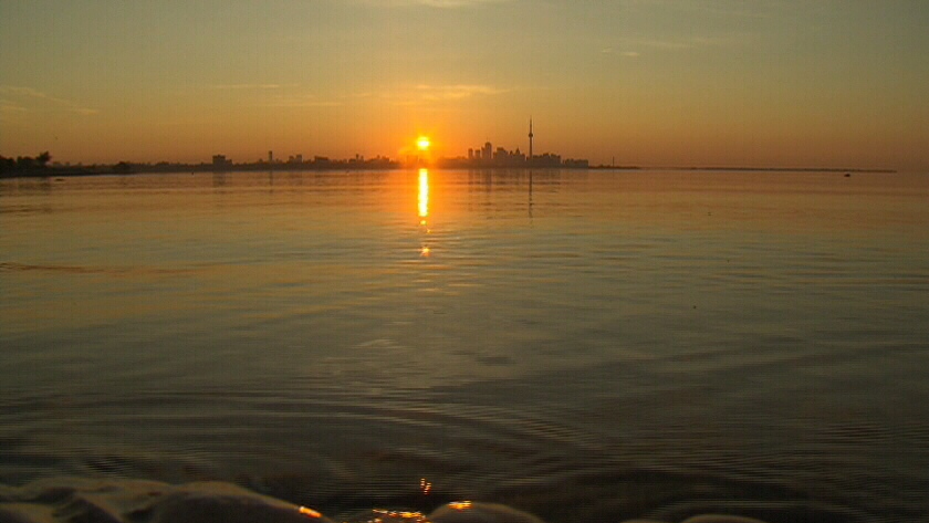 The sun rises over the Toronto skyline, Tuesday, July 3, 2012. 