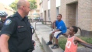 A police officer speaks to children who live in 32 Division on Tuesday, July 3, 2012.