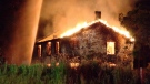 A house is engulfed by flames, forcing the closing the Donald Cousens Parkway at Highway 7,  around midnight on Friday, July 16, 2010. 