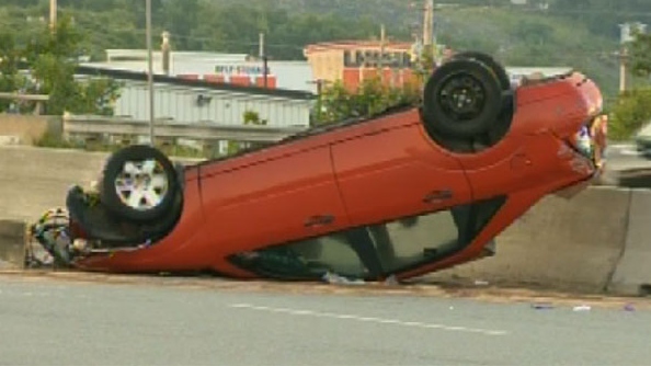 Police say two people were sent to hospital after the driver lost control of this vehicle as he approached the MacKay Bridge toll around 5 a.m. Wednesday. The car then flipped and slid 200 metres on its roof, before striking the median. 
