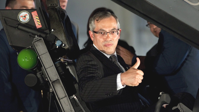 Minister of Industry Tony Clement gives the thumbs up as he sits in the cockpit of the F-35 Joint Strike Fighter following an announcement in Ottawa, Friday July 16, 2010. (Adrian Wyld / THE CANADIAN PRESS)