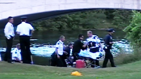 Emergency workers remove the body of Avery Pringle, 4, from the waters of the Otonabee River in Peterborough on the evening of Thursday, July 15, 2010.
