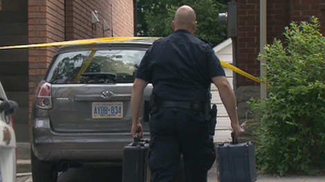 An officer is seen at a north Toronto home where a three-year-old child was pulled from a backyard pool on Saturday, July 17, 2010.