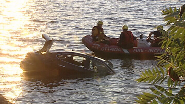 Ottawa fire crews investigate an abandoned vehicle in the Ottawa River Wednesday, July 4, 2012.