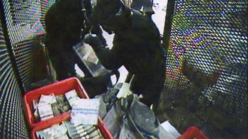 This CCTV image of Sept. 23, 2009 made available by Swedish Police July 19, 2010 shows two of several robbers inside the G4S cash depot in Stockholm, Sweden. (AP / Swedish Police)