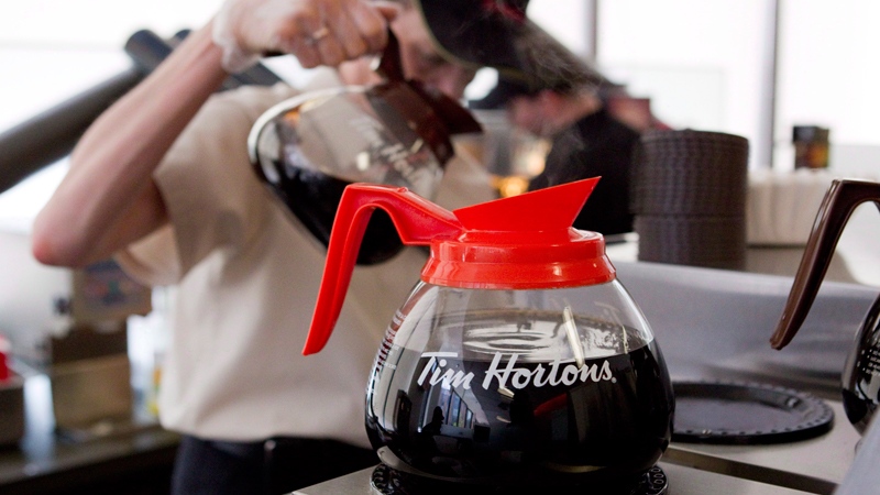 A server pours a cup of coffee at the Tim Hortons