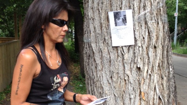 Dolly Felix posters the neighbourhood where her nephew Johnathen Felix was found dead in March. 
