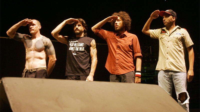 Members of the band Rage Against the Machine salute veterans during an anti-war concert at the Democratic National Convention in Denver on Aug. 27, 2008. (AP / Jeff Chiu)