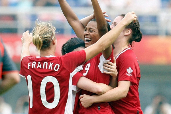 Martina Franko of Canada, left, celebrates with teamates after scoring against Argentina during their Women's Group E, first round soccer match at the Beijing 2008 Olympics in Tianjin, Wednesday, August 6, 2008. The other teams in Group E are Sweden and China. (AP Photo/Michael Sohn)