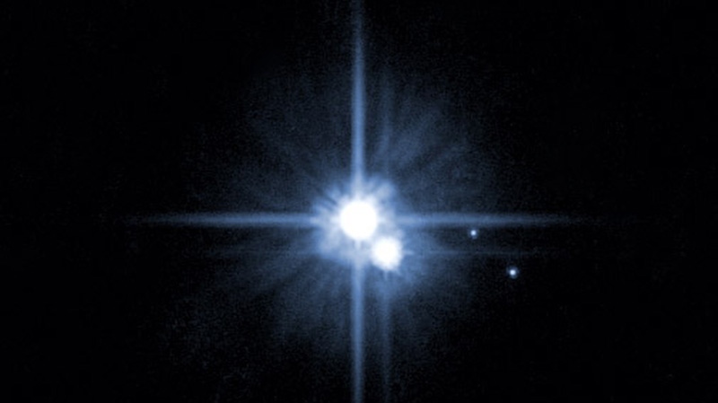 This file image from NASA's Hubble Space Telescope shows Pluto and three of its moons.