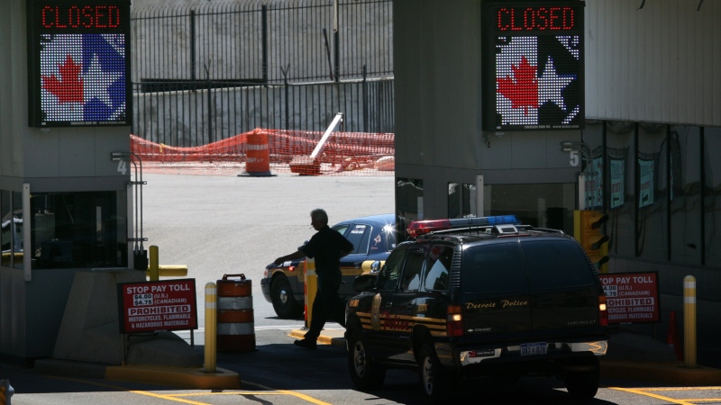 Police vehicles stand at toll booths on the Detroit side of the temporarily closed Detroit Windsor Tunnel on Thursday, July 12, 2012. (AP / Detroit Free Press, Susan Tusa)