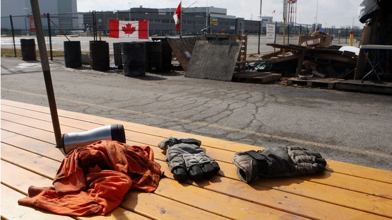 Gloves, a shirt and a coffee mug are left behind on a deserted picket line in London, Ont.