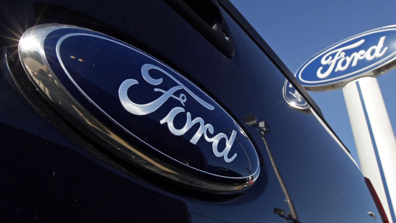 This Oct. 25, 2011 file photo shows a Ford logo on the tailgate of a pick-up truck at a dealership i