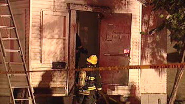 Fire crews work to extinguish a blaze in a rooming house on Euclid Avenue Friday night. 