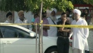 Friends and family gather at the scene of a fatal hit-and-run in Brampton, Ont., on Monday, July 16, 2012.