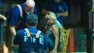 A female victim is treated for a wound to her lower back outside a Scarborough laundromat on Monday, July 16, 2012.