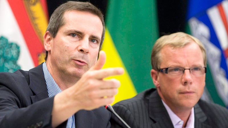 Ontario Premier Dalton McGuinty, left, and Saskatchewan Premier Brad Wall speak to media following meeting of the Council of the Federation in Regina, Sask., Friday, Aug. 7, 2009. (Geoff Howe / THE CANADIAN PRESS)