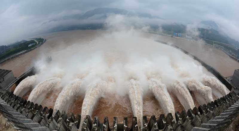 In this photo released by China's Xinhua news agency, flood water is released from the Three Gorges Dam's floodgates in Yichang, in central China's Hubei province, Tuesday, July 20, 2010.(AP Photo/Xinhua, Cheng Min)
