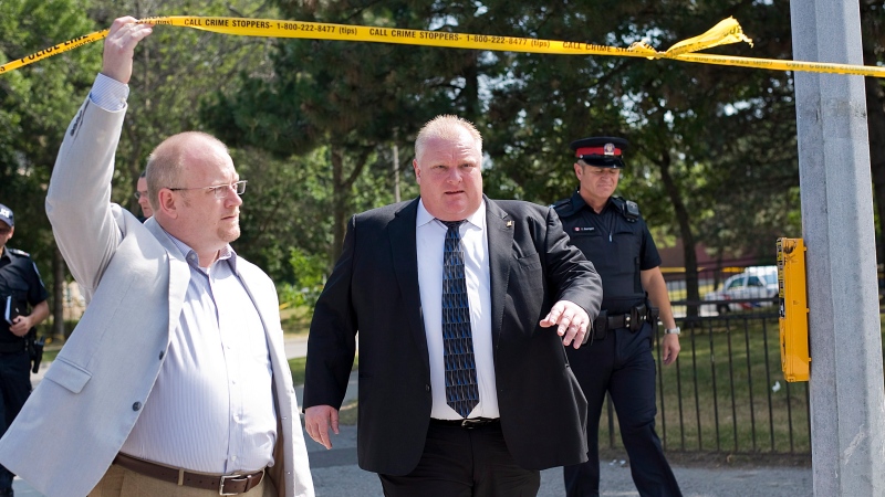 Mayor Rob Ford (right) visits the scene of Monday night's shooting on Danzig Street in Toronto on Tuesday, July 17, 2012. (Aaron Vincent Elkaim/THE CANADIAN PRESS)