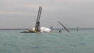 Part of a commercial dredge, the Arthur J, can still be seen above the waters of Lake Huron after it sank off of Lakeport, Mich., spilling an unknown amount of diesel fuel early Thursday, July 19, 2012. (AP Photo/U.S. Coast Guard via The Port Huron Times Herald) NO SALES