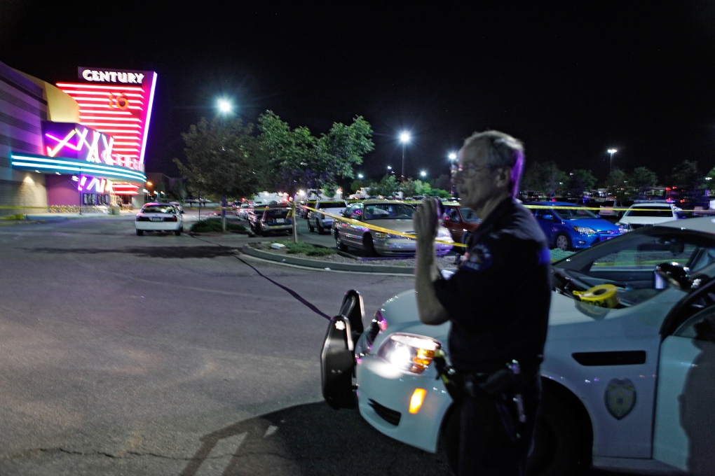 An Aurora Police officer talks on his radio outside of the Century 16 theater at Aurora Mall 