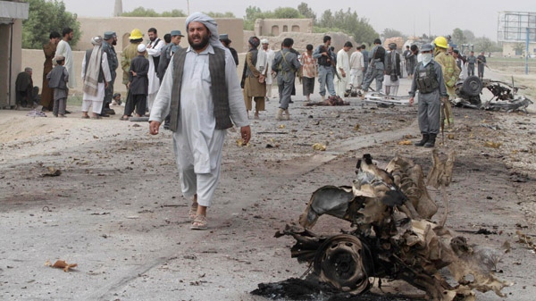 People gather at the scene of a suicide bombing that killed five children in Kandahar province's Dand district Monday, Aug. 2, 2010. (AP / Allauddin Khan)