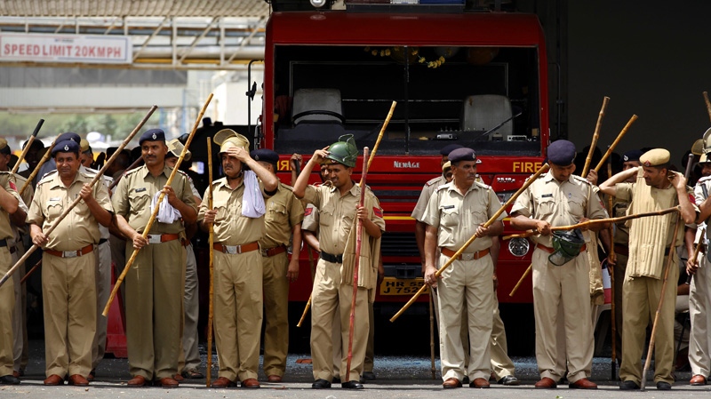 Policemen stand inside the Maruti Suzuki factory in Manesar, on the outskirts of New Delhi.