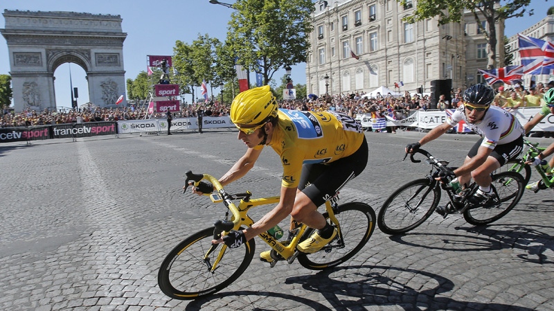 Bradley Wiggins, in yellow, passes the Arc de Triomphe in Paris, France on July 22, 2012.