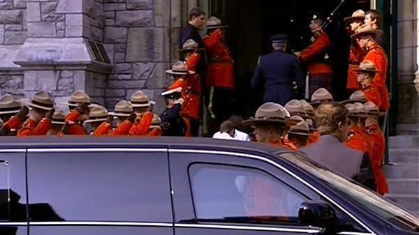 RCMP members salute their fallen comrade, Const. Michael Potvin, at a memorial service at Saint Patrick's Basilica in Ottawa, Wednesday, Aug. 4, 2010.